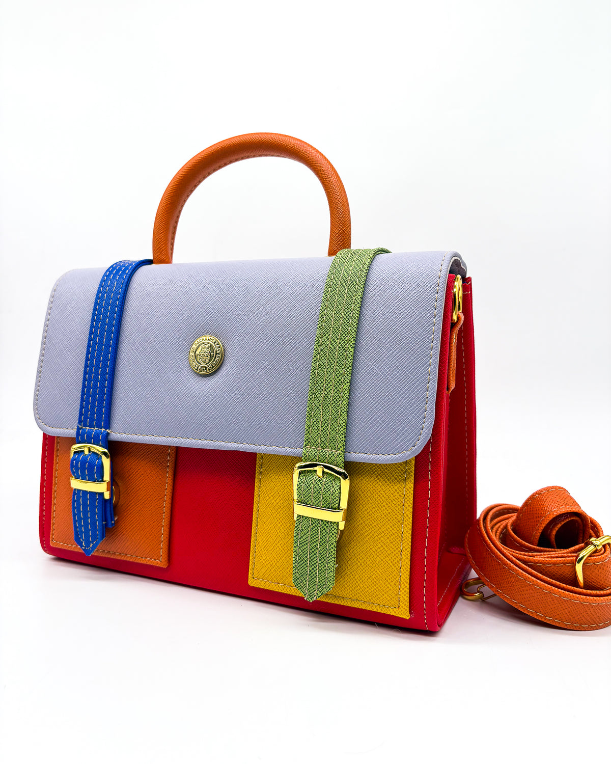 Electric red vegan leather handbag or crossbody bag, with African Wax fabric inlay, two gold buckles and a magnetic clasp.