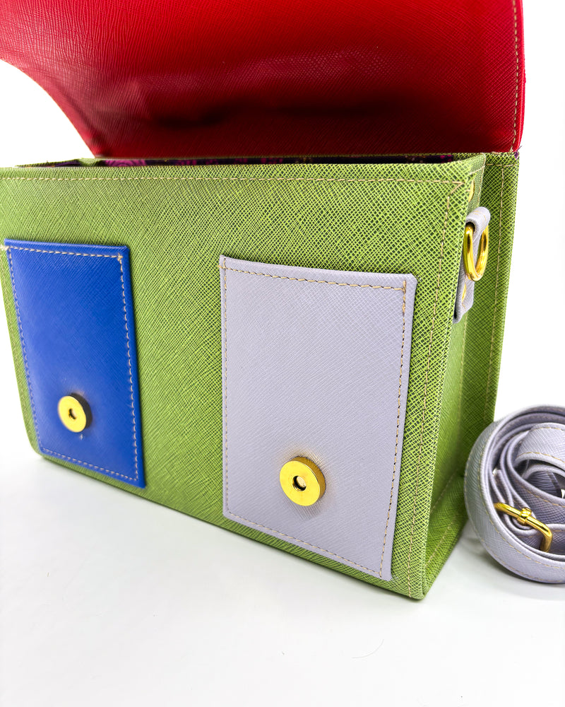 Open view, green vegan leather handbag or crossbody bag, with African Wax fabric inlay, two gold buckles and a magnetic clasp.