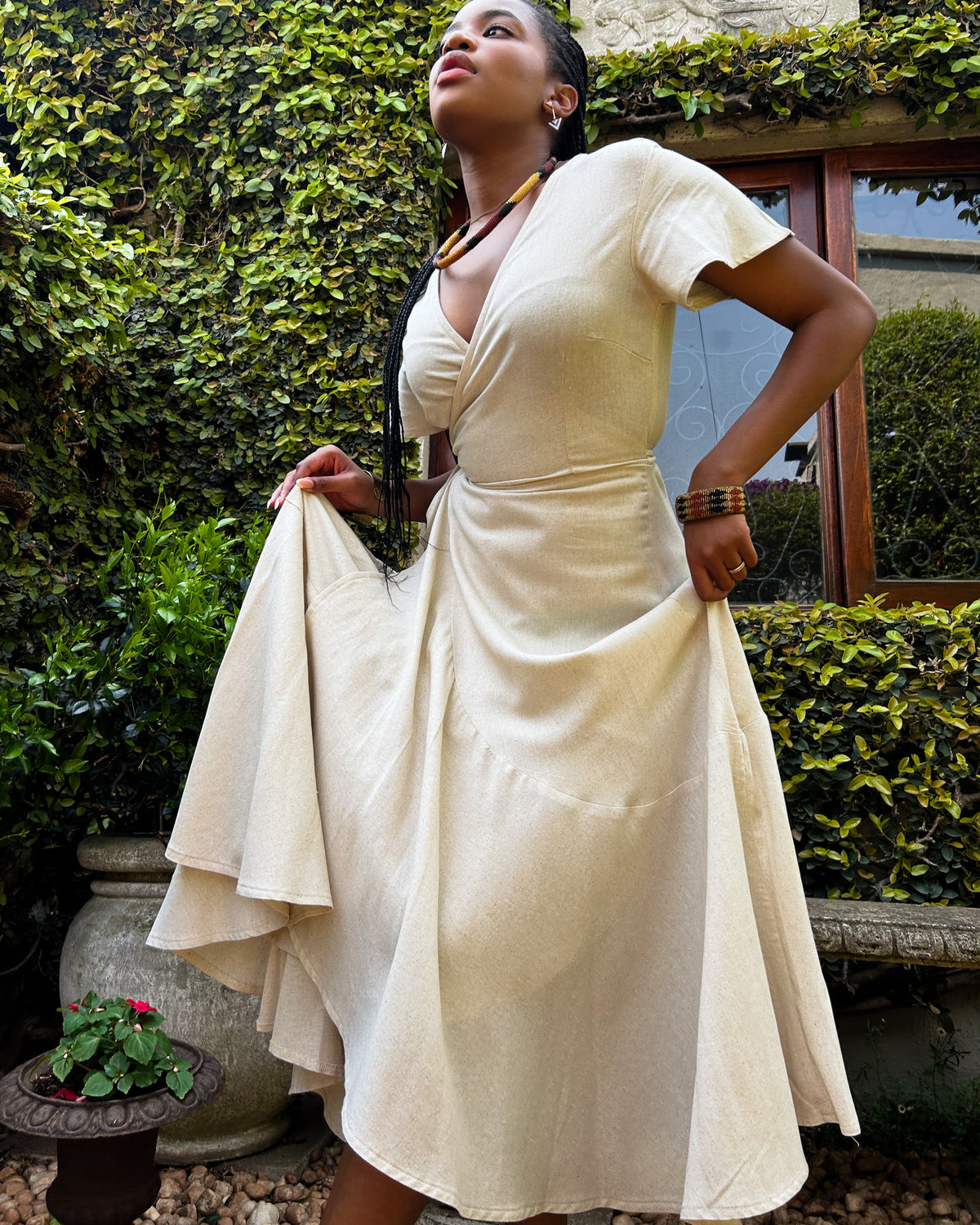 African woman wearing a natural colour Christine dress.