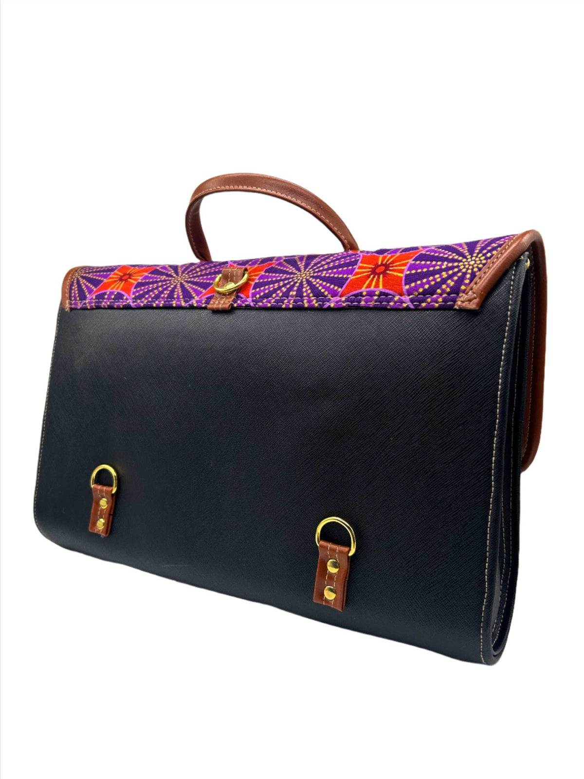 Back angle, black vegan leather handbag, backpack or crossbody bag with red and purple African wax fabric inlay and two gold buckled clasps.