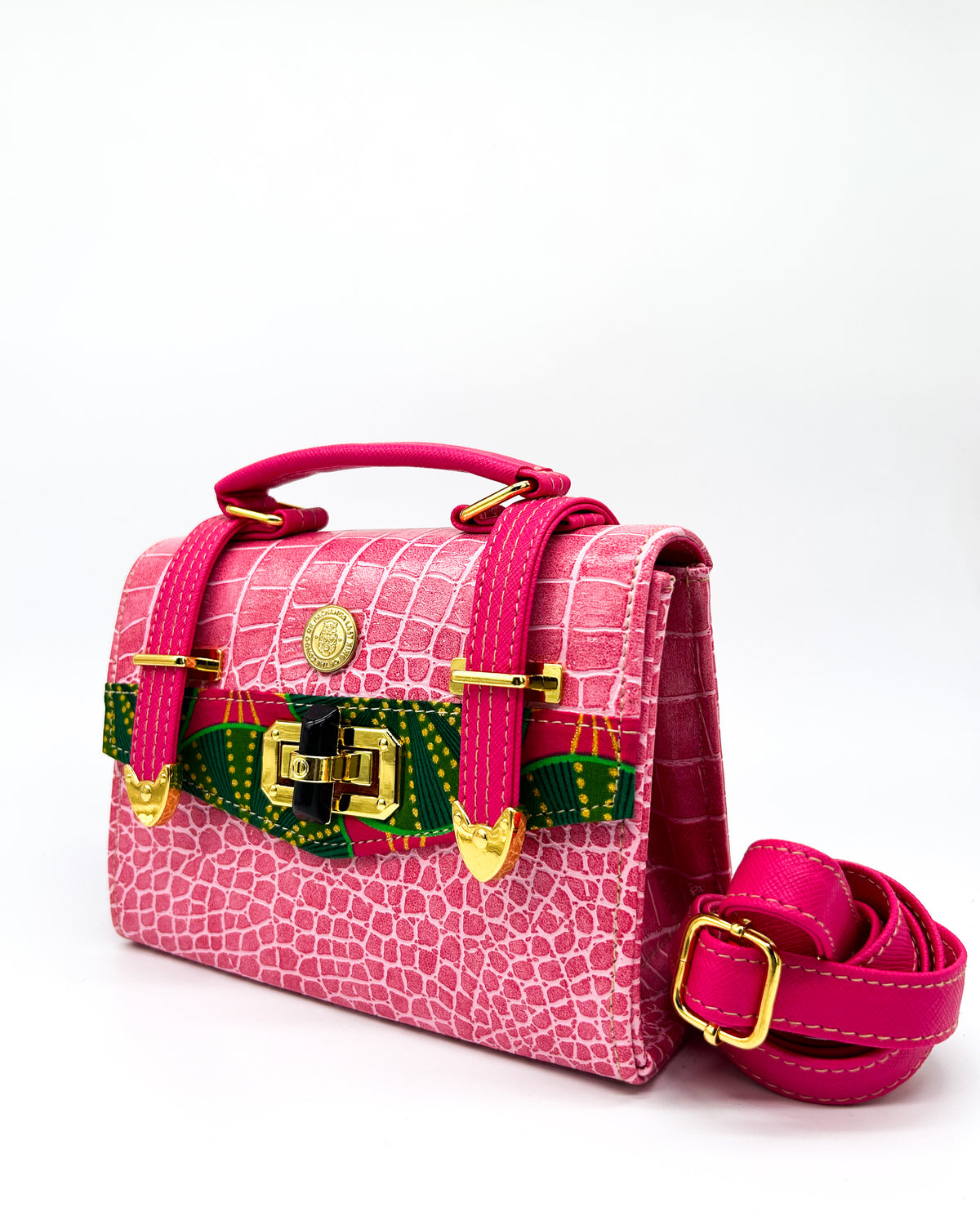 Pink textured vegan leather clutch bag with two gold buckles, twist-lock and adjustable strap.