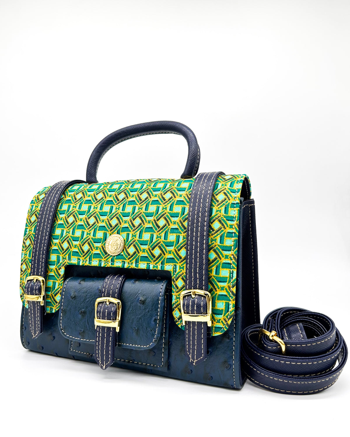 Navy vegan leather handbag or crossbody bag with green and gold African wax fabric inlay, three gold buckles and a magnetic clasp.