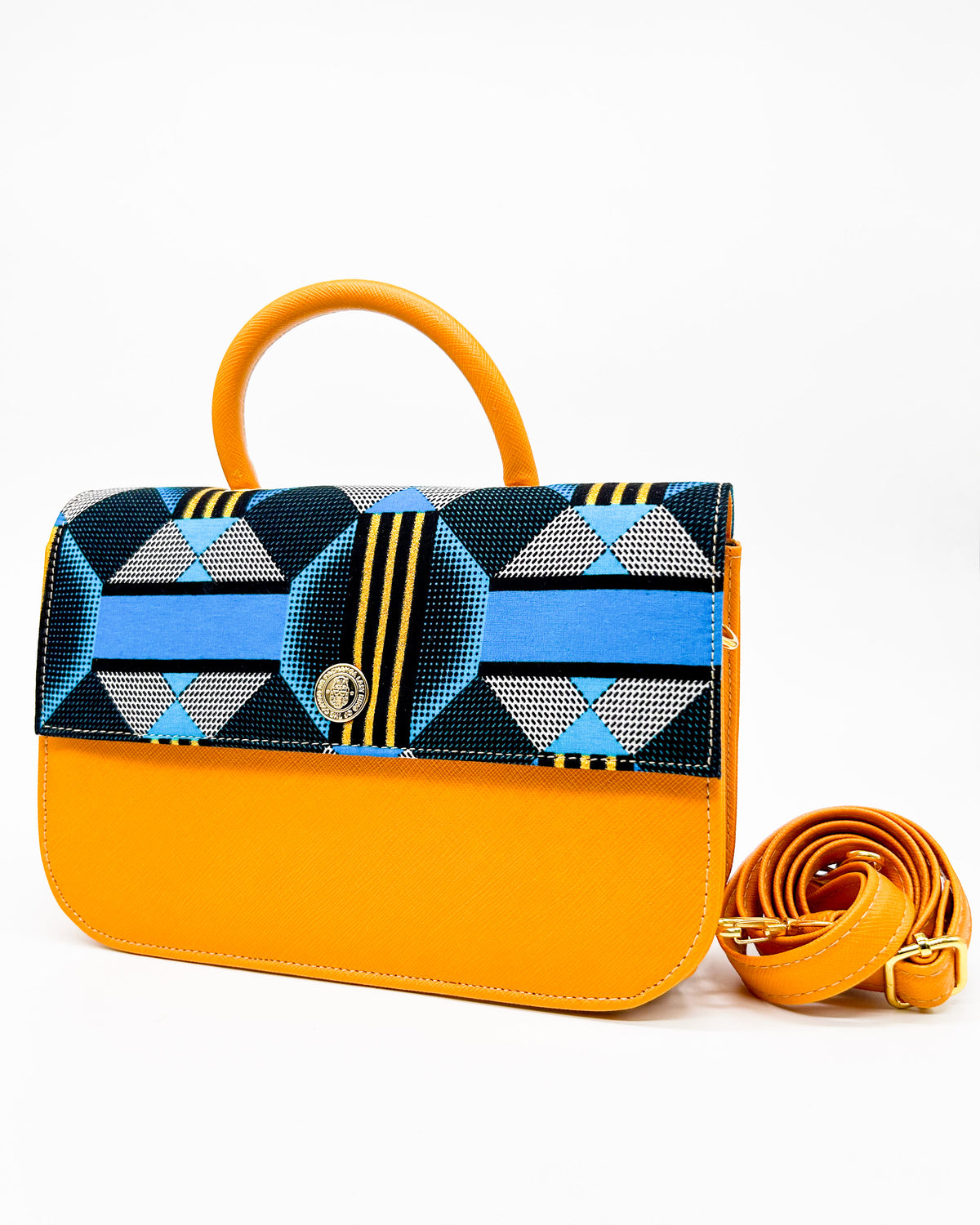 Orange vegan leather handbag with yellow and blue African Gold Wax fabric inlay, gold magnetic clasp and adjustable strap.