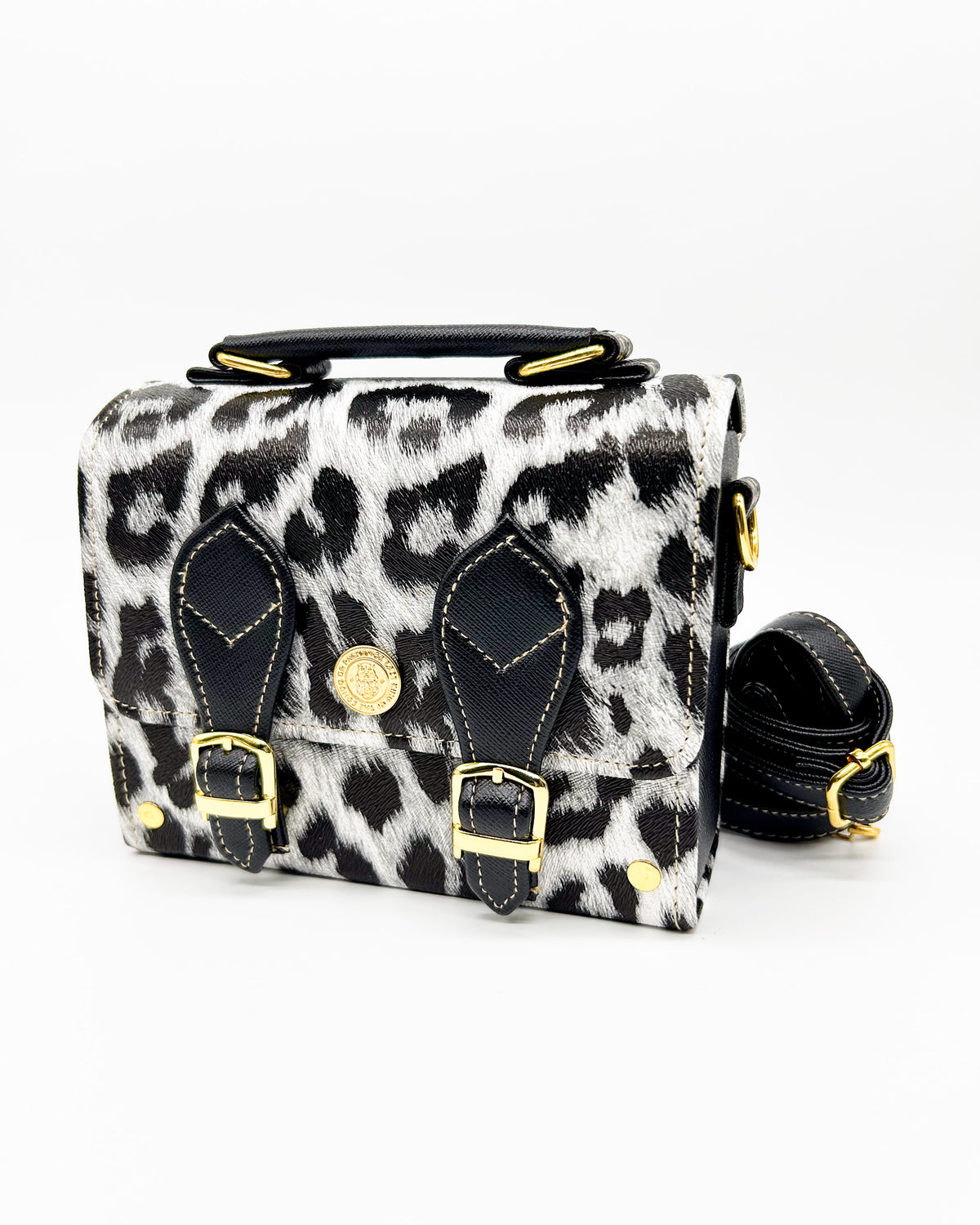 Black and white leopard print vegan leather handbag, backpack or crossbody bag with two gold buckled clasps.