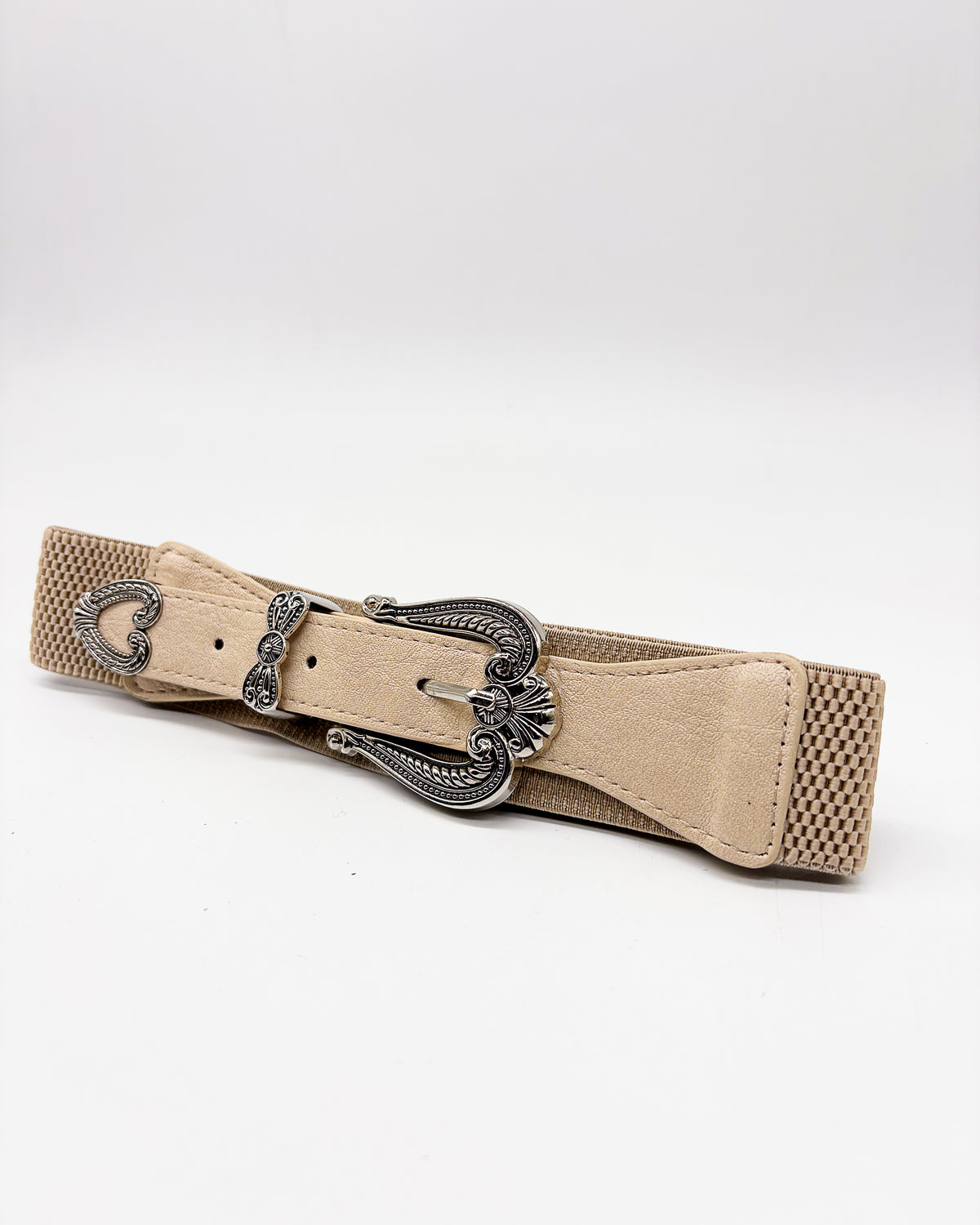 Beige belt with a decorative silver buckle on a white background