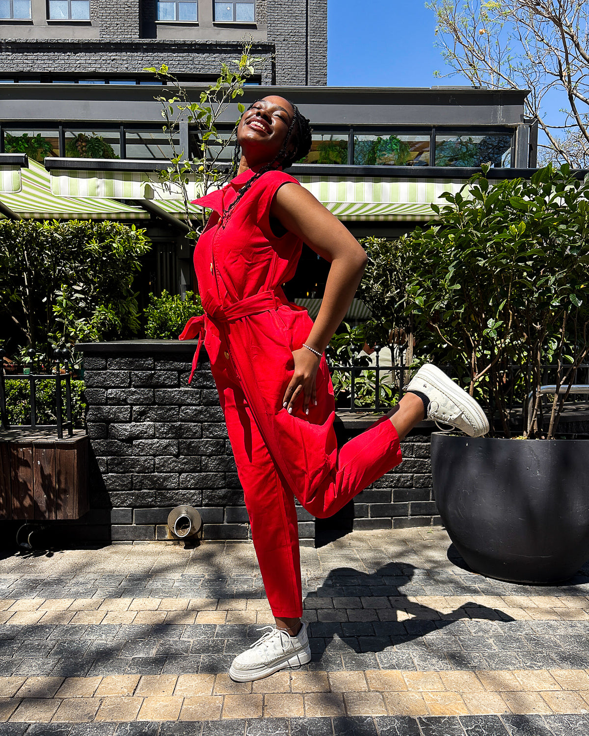 Woman wearing the Anna Elsabie Long Jumpsuit in cotton twill by Dr Pachanga Clothing, South Africa.