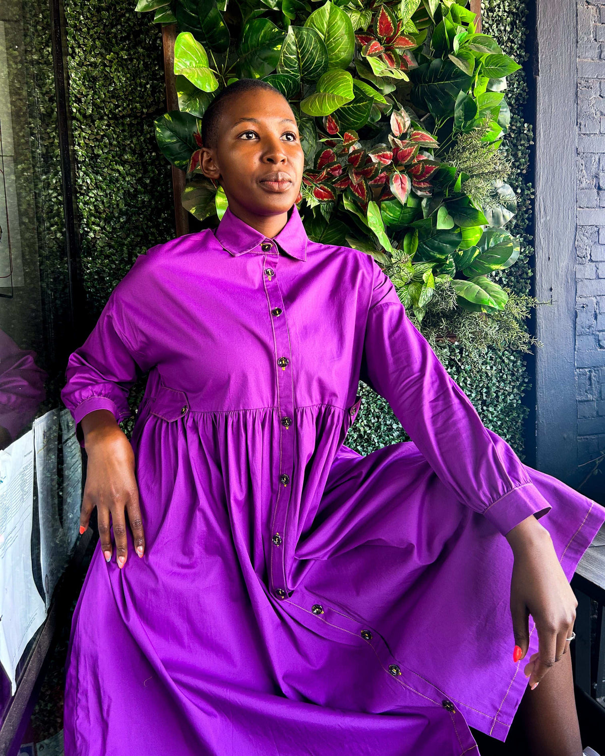 African woman wearing a Mimi Dress in purple.