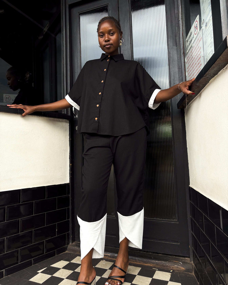 African woman wearing Dr Pachanga two-tone Kate Pants in black and white.