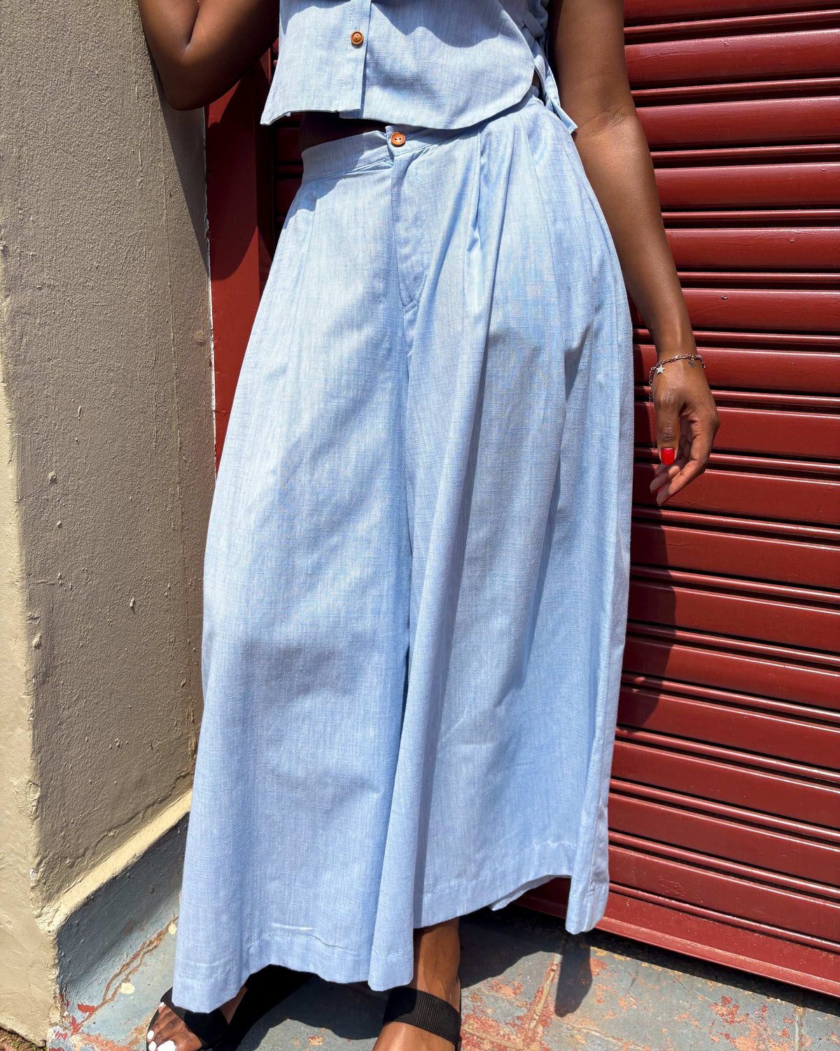 African woman wearing Buhle sky colour pants.