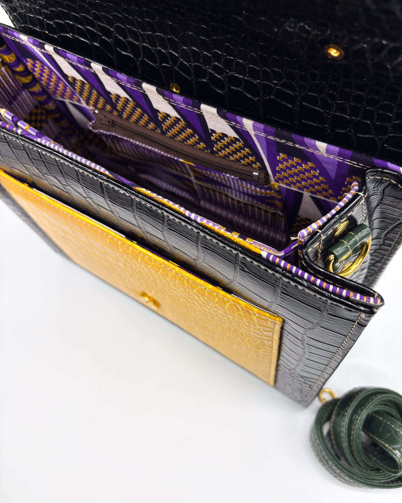 Inside view, animal print vegan leather handbag, crossbody or backpack with African wax fabric accents, a gold buckle and a magnetic clasp.