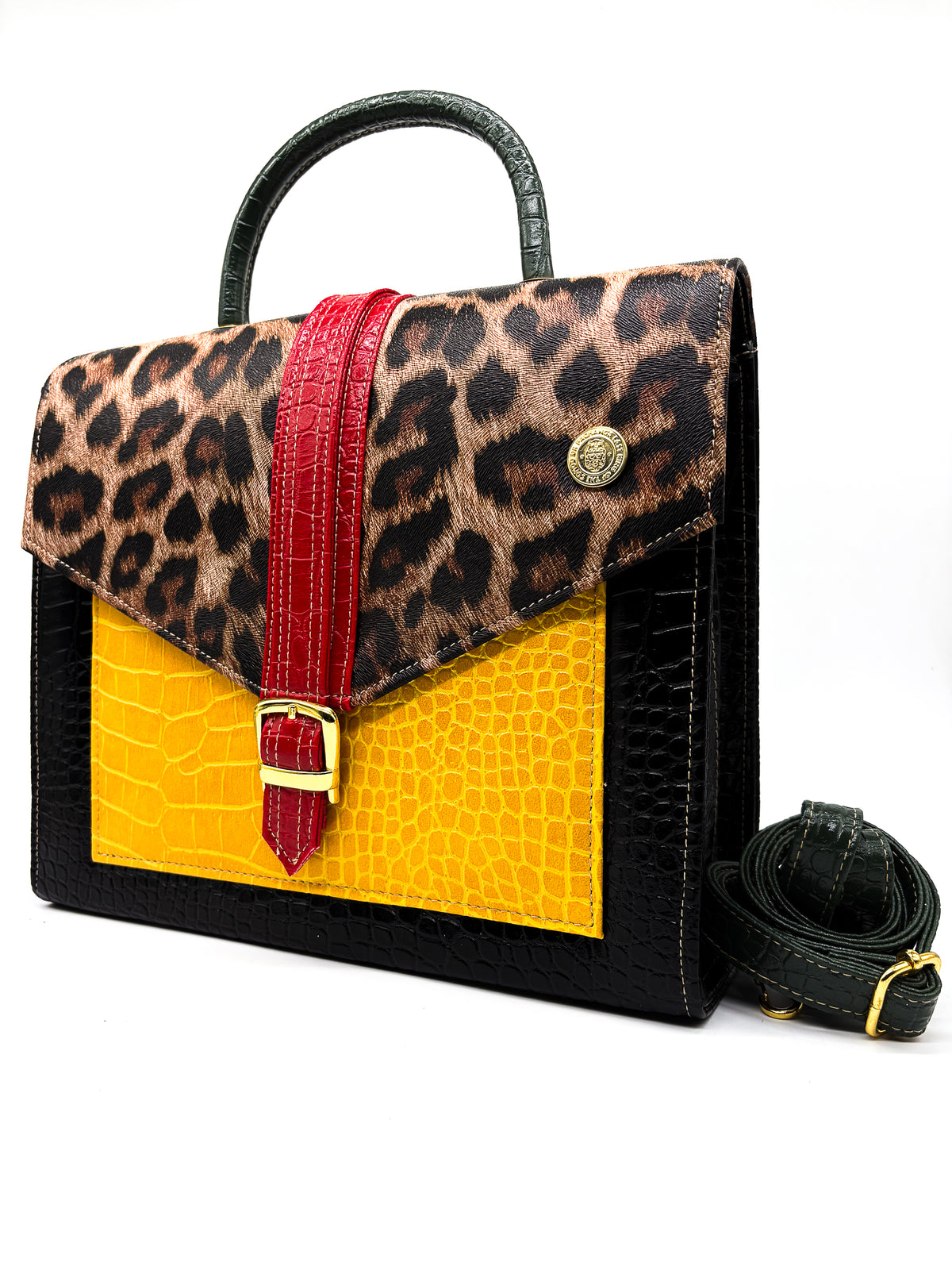 Animal print, yellow, red and black vegan leather handbag, crossbody or backpack with African wax fabric accents, a gold buckle and a magnetic clasp.