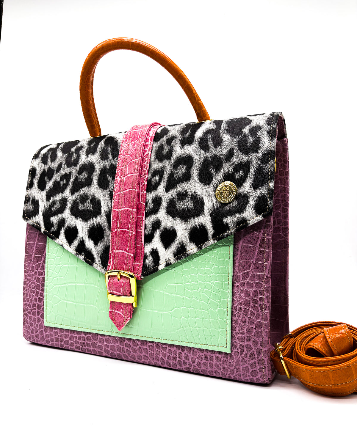 Purple, green and animal print vegan leather handbag, crossbody or backpack with African wax fabric accent, a gold buckle and a magnetic clasp.