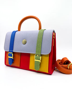 Electric red vegan leather handbag or crossbody bag, with African Wax fabric inlay, two gold buckles and a magnetic clasp.