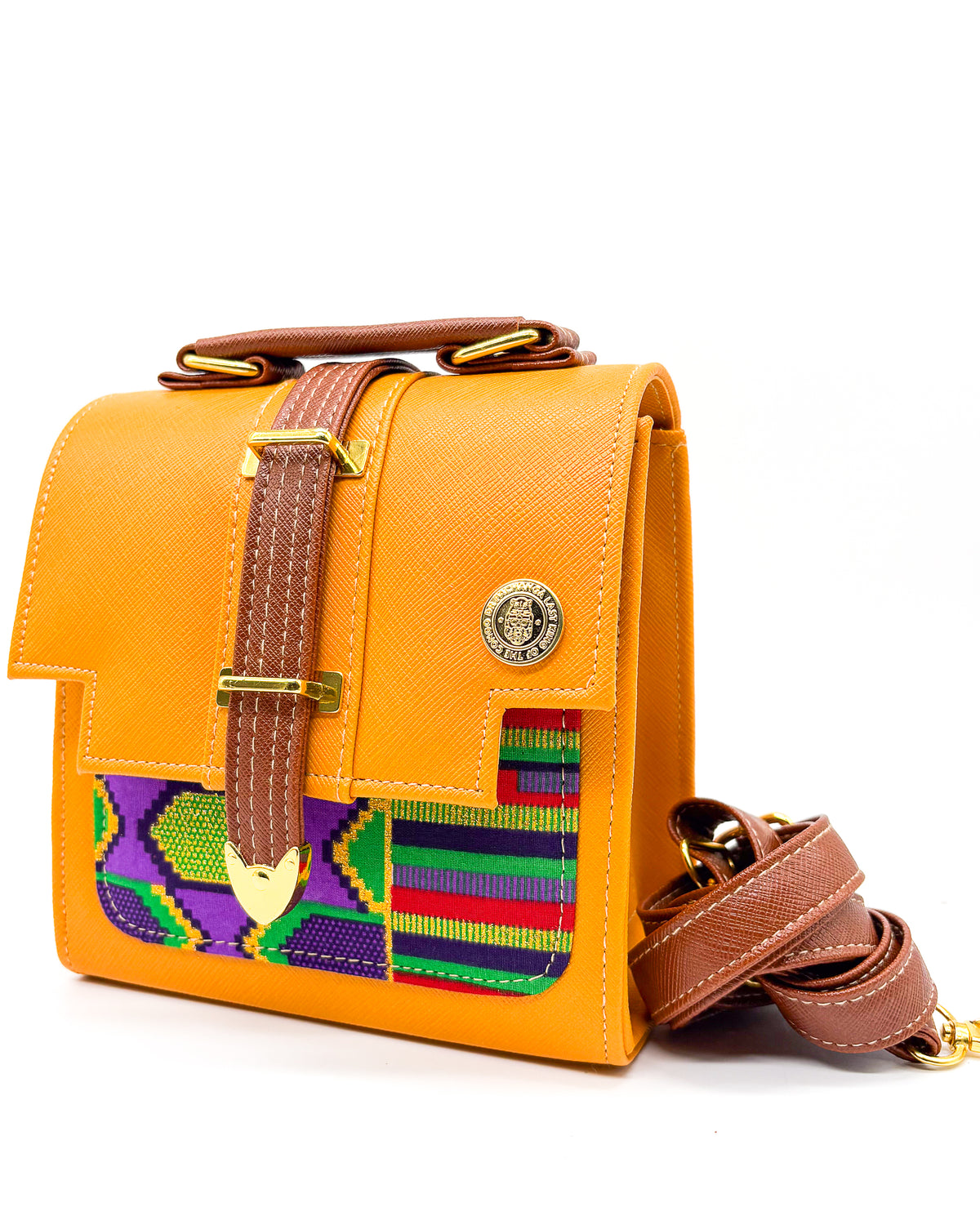 Orange vegan leather handbag or crossbody bag with colourful African wax fabric inlay, and a gold magnetic clasp.