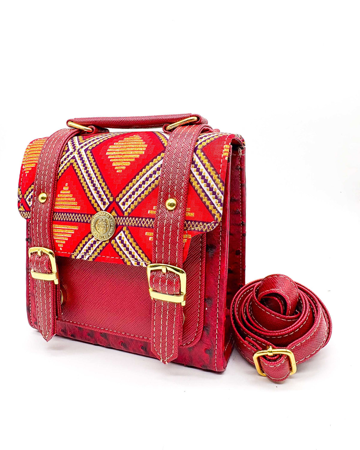 Maroon vegan leather handbag or crossbody bag with red and gold African Wax fabric inlay, two gold buckles and magnetic clasp.