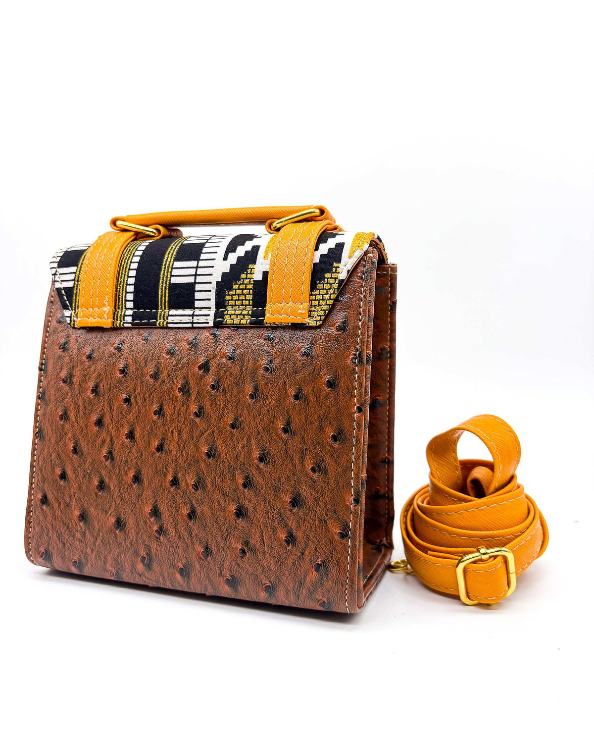 Back view, brown vegan leather handbag or crossbody bag with orange accents, gold African Wax fabric inlay, two gold buckles and magnetic clasp.