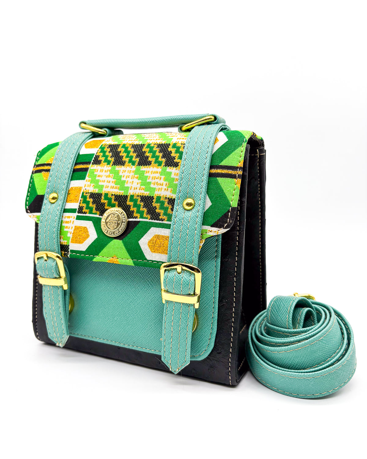 Black vegan leather handbag or crossbody bag with teal accents, and green and gold African Wax fabric inlay, two gold buckles and magnetic clasp.