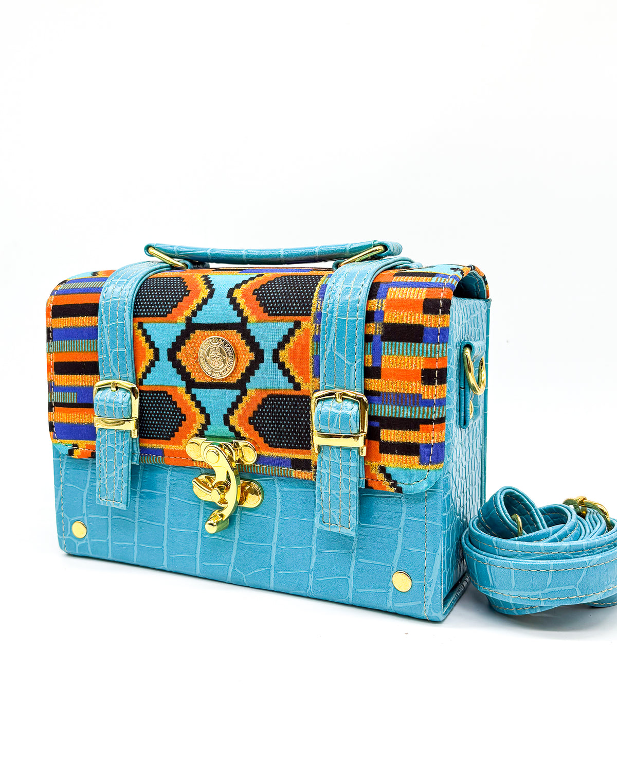 Light blue textured vegan leather handbag or crossbody bag with colourful African wax fabric inlay, two gold buckles and a gold clasp.