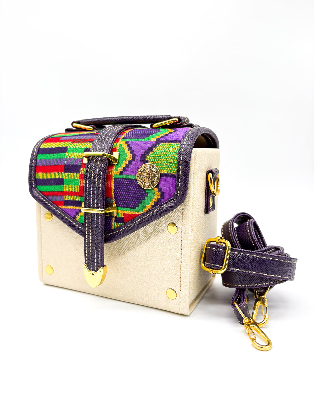 Off white vegan leather handbag or crossbody bag, with colourful African Wax fabric inlay, a gold buckle and magnetic clasp.