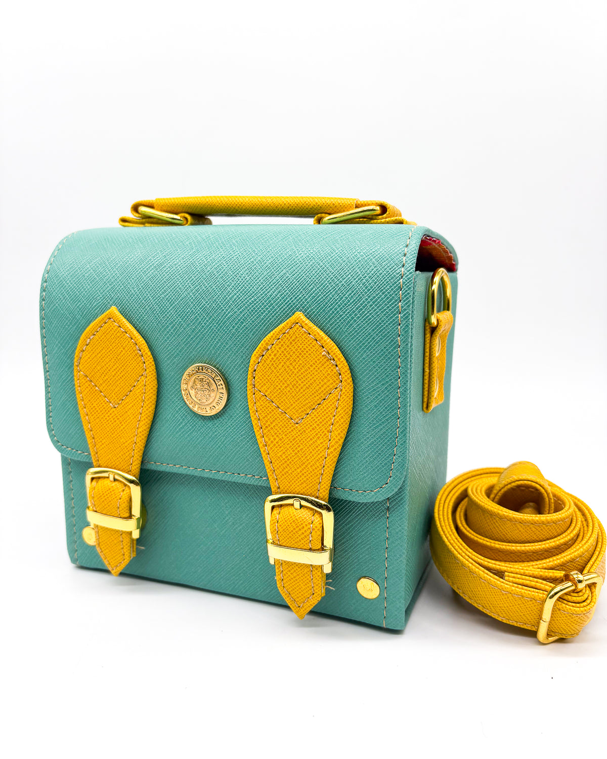 Teal and yellow vegan leather handbag or crossbody bag with African wax fabric interior lining, two gold buckles and a magnetic clasp.