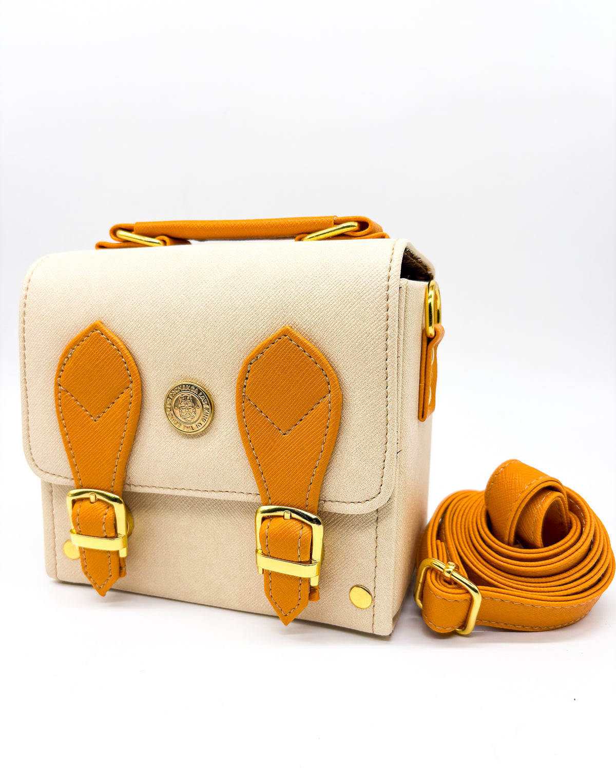 Off white vegan leather handbag or crossbody bag with African wax fabric interior lining, two gold buckles and a magnetic clasp.