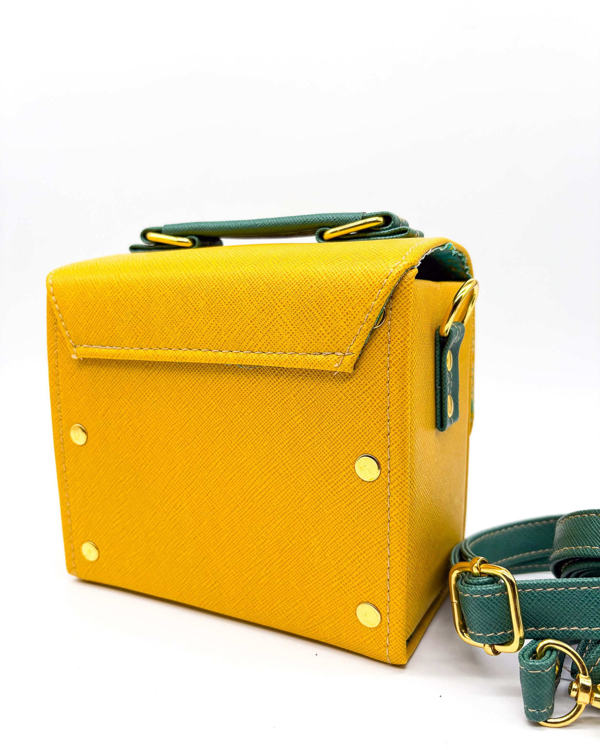 Back view, yellow and green vegan leather handbag or crossbody bag with African wax fabric interior lining, two gold buckles and a magnetic clasp.
