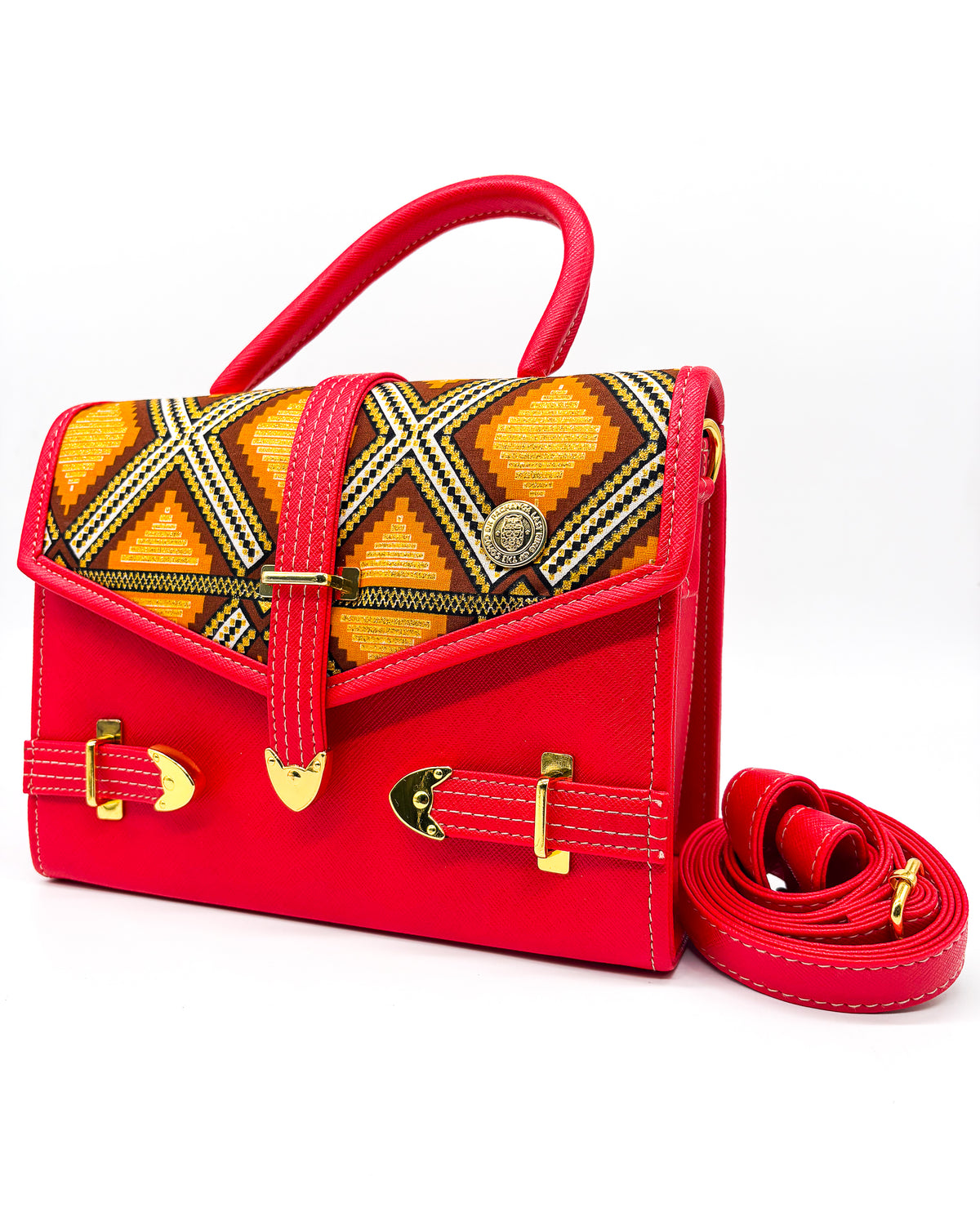 Electric red vegan leather handbag or crossbody bag, with orange and gold African Wax fabric inlay, three gold buckles and a magnetic clasp.