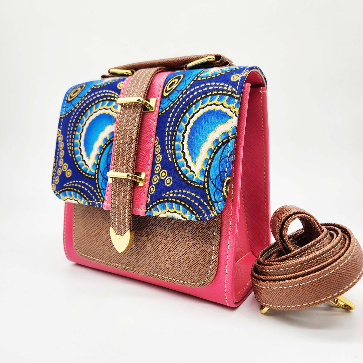 Pink and brown vegan leather handbag or crossbody bag with blue and yellow African wax fabric inlay, and a gold magnetic clasp.